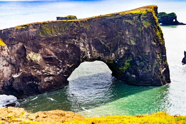 istock Dyrholaey Arch with Hole Reynisfjara Black Sand Beach Iceland 1227465564