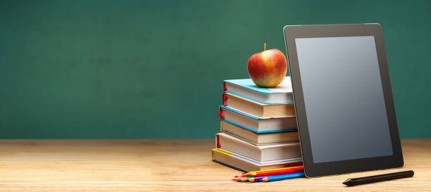 online education. books and tablet on the desktop on blackboard - blackboard book education back to school imagens e fotografias de stock