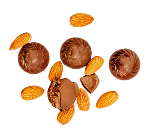Chocolate candies with almond nuts  isolated on white background. Top view.  Food Creativa layout