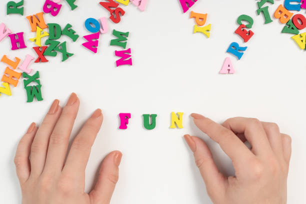 istock Joy and happiness concept. Female hands spread the word fun from colored letters 1227472253