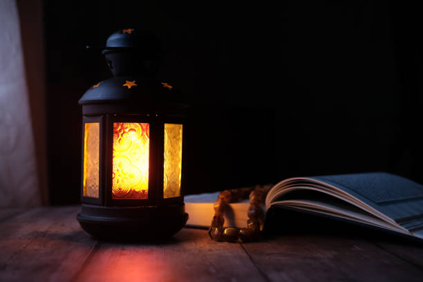 istock Ornamental Arabic lantern with burning candle glowing at night 1227475083