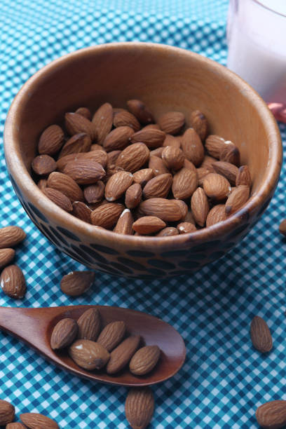 istock Top view of almond nuts and milk on table 1227475135
