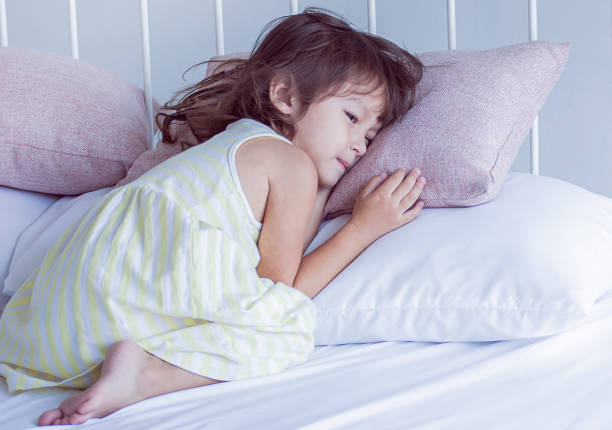 istock Little girl getting sick and sleeping on bed 1227477474