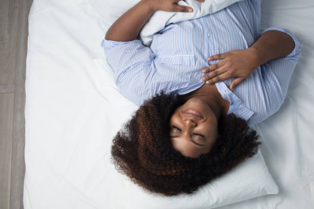 awesome woman having a pleasant dream awesome woman having a pleasant dream, top view photo. good night sleep pudgy woman pictures stock pictures, royalty-free photos & images