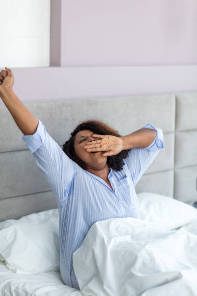 istock young afro woman is waking up 1227480885