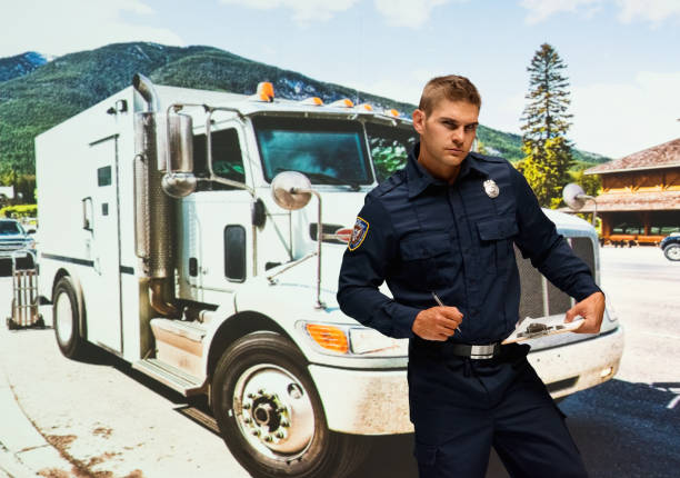 Caucasian young male security staff wearing uniform and holding contract Waist up of with brown hair caucasian young male security staff wearing uniform who is confident and holding contract armored truck stock pictures, royalty-free photos & images