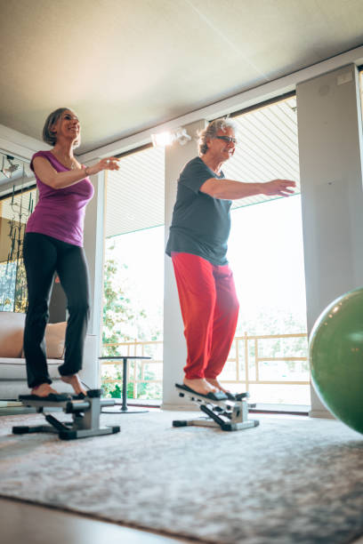 istock mature adult couple doing exercize at home 1227481749