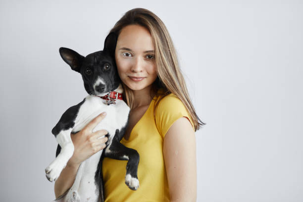 attractive brown-haired girl adores pets. close up photo. interest, hobby, lifestyle, studio shot