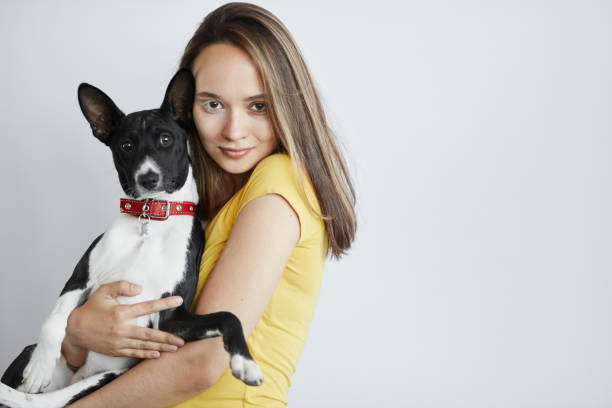 istock beautiful young woman hugging, embracing her dog 1227482140