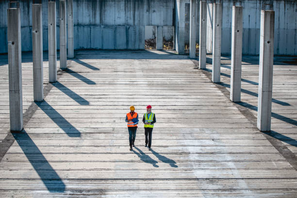 istock Foreman and Manager Walking Length of Construction Site 1227486037