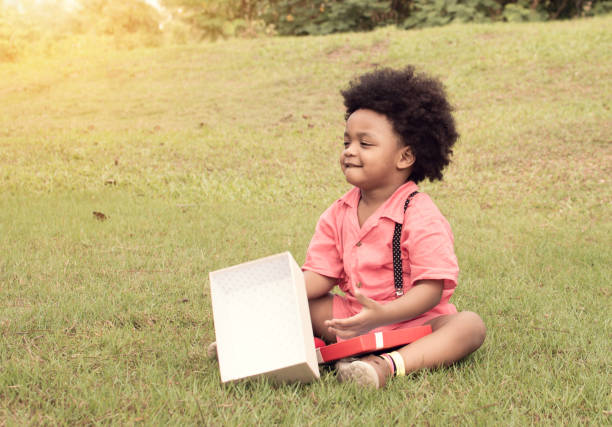 istock African boy is openning gift box for his birthday 1227486175