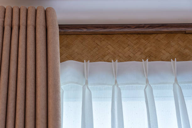 istock Window beige curtains and white tulle on the curtain rod 1227486217