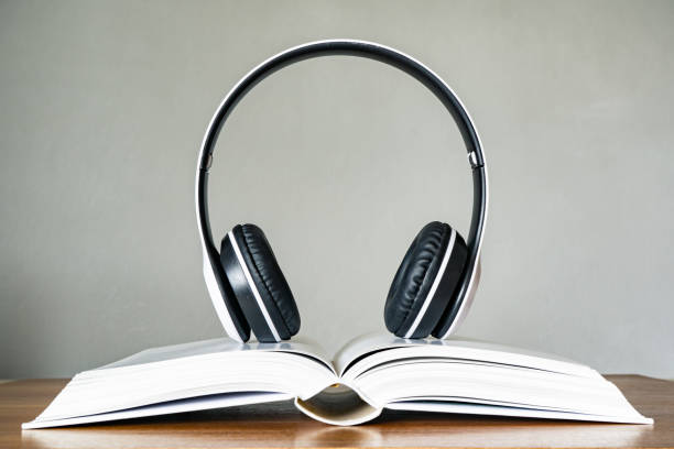 istock Hardcover book with headphone. Audio book concept. 1227488217