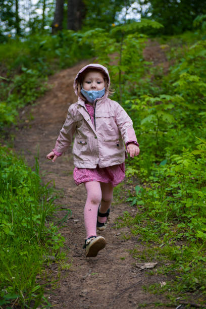 istock Three year old girl runs in the park 1227488601