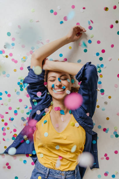 istock Woman lying on a floor covered with confetti 1227488647
