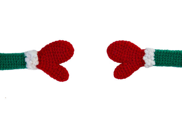 knitted toy red mittens on green sleeves with gray cuffs towards each other horizontally, isolate - glove winter wool touching imagens e fotografias de stock