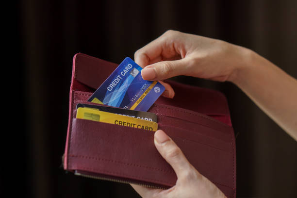 istock Hand holding wallet and take out credit card. 1227493401