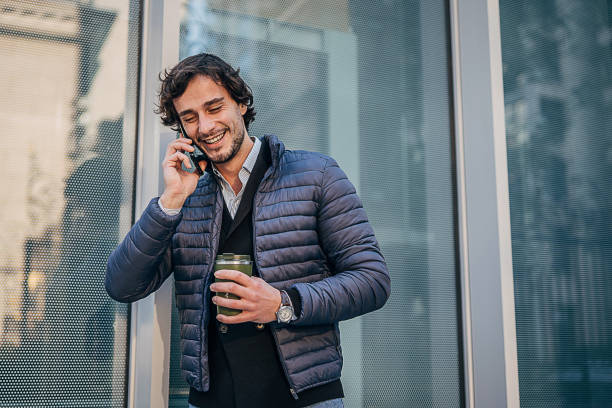 istock Handsome man talking on mobile on the street downtown 1227497578