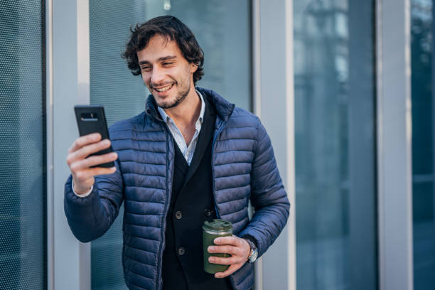 istock Handsome man using mobile on the street downtown 1227498104