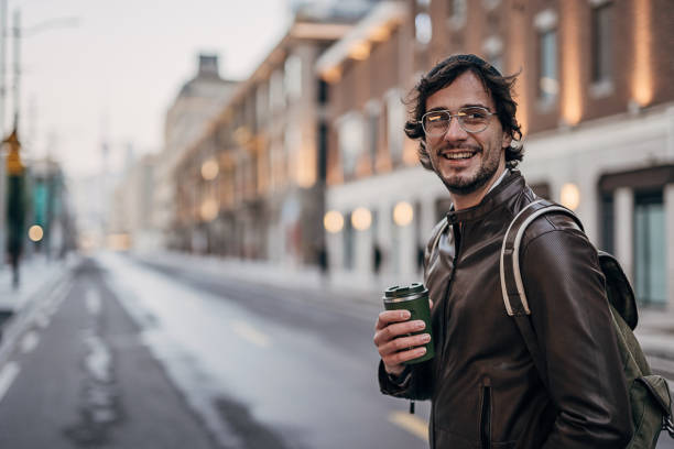 istock Handsome man with coffee cup on the street downtown 1227498673