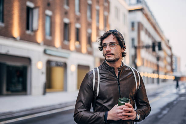 istock Modern man with coffee cup on the street downtown 1227499267