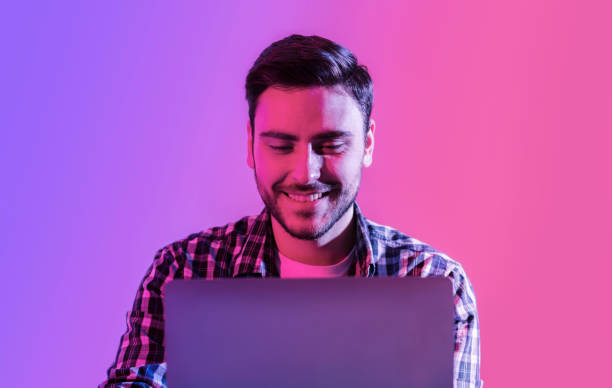 istock Freelancer at work. Young smiling man with laptop 1227499354