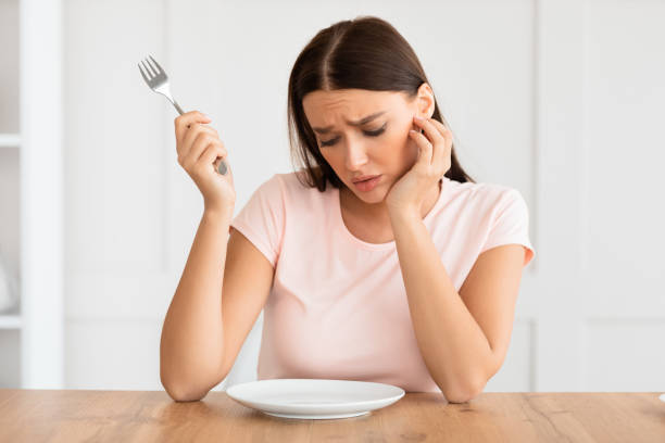 istock Hungry Woman Looking At Empty Plate Slimming At Home 1227500699