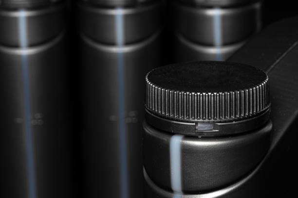 istock Engine oil bottle on black background, close up. 1227502482