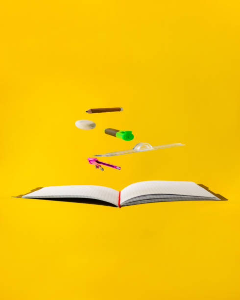 istock Levitating school supplies for math - notebook, pen, ruler, pencil, divider and eraser on yellow background. Concept of education and creativity 1227503379