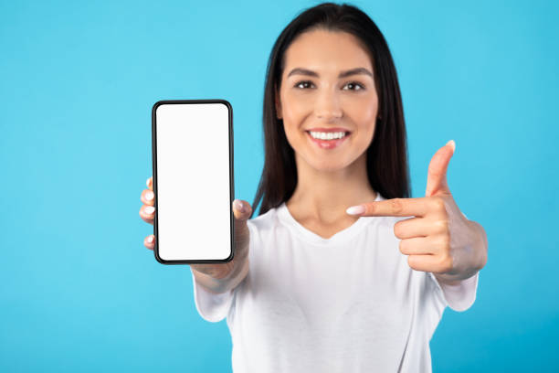 istock Girl showing white blank cell phone screen 1227503431