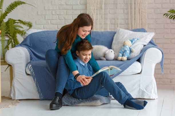 istock Brother and sister are reading a book. 1227506669
