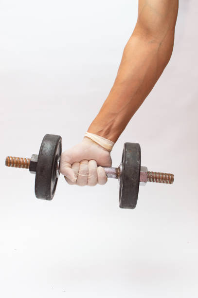 istock dumbbell ind hand wearing gloves 1227506977