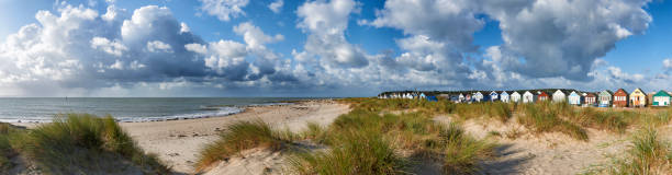 istock Panoramic view of Beach Huts overlooking beach and sea in Mudeford,Dorset 1227508889