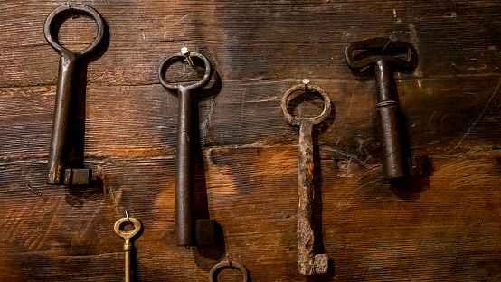 antique keys are on the wood