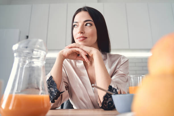 istock Thoughtful young woman having breakfast at home 1227512264