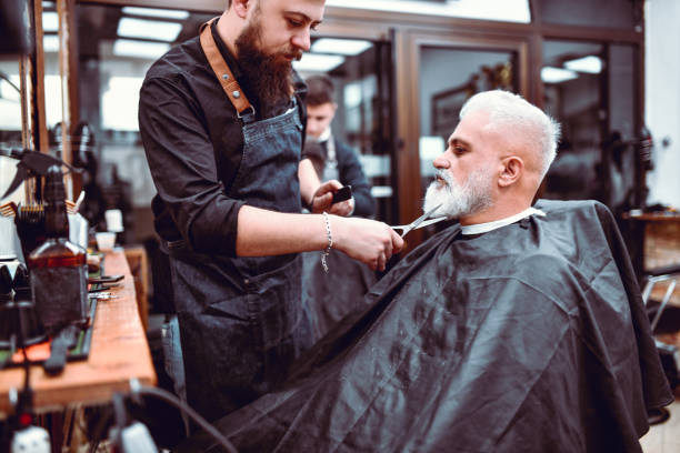 Barber Styling Senior Male's Beard Barber Styling Senior Male's Beard antelope photos stock pictures, royalty-free photos & images