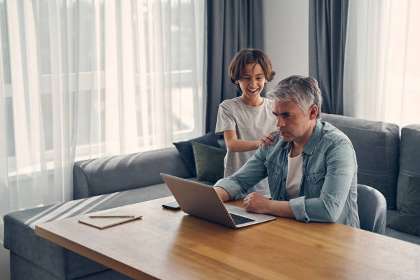 istock Parent and kid staying at home in cozy atmosphere 1227514620