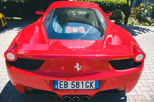 Maranello, Italy - May 26, 2010: Rear end of red Ferrari 458 Italia parked near Ferrari Museum at Maranello, Italy. There are many test drive points around that area where you can rent and drive variuos sports cars, mostly Ferarris. This one was also ready for a test drive.