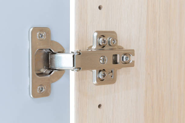 istock Polished Stainless door hinge on a cabinet door for interior design. 1227515588