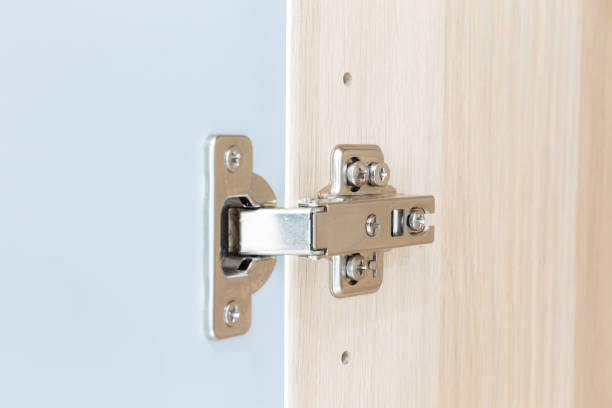 istock Polished Stainless door hinge on a cabinet door for interior design. 1227515606