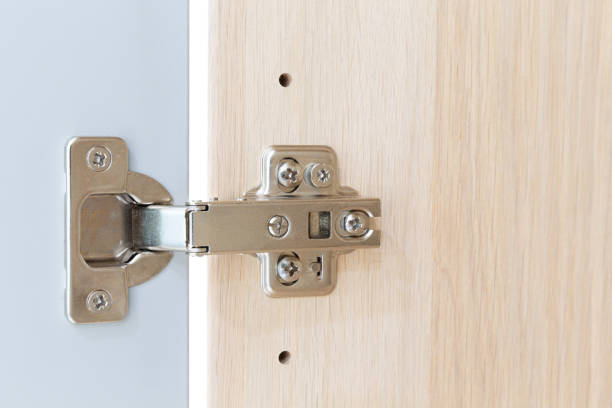 istock Polished Stainless door hinge on a cabinet door for interior design. 1227515608