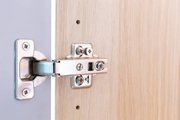 istock Polished Stainless door hinge on a cabinet door for interior design. 1227515687