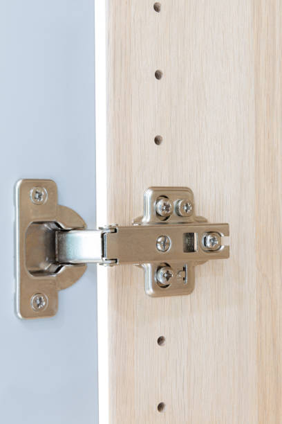 istock Polished Stainless door hinge on a cabinet door for interior design. 1227515785
