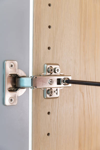 istock Polished Stainless door hinge on a cabinet door for interior design. 1227515838
