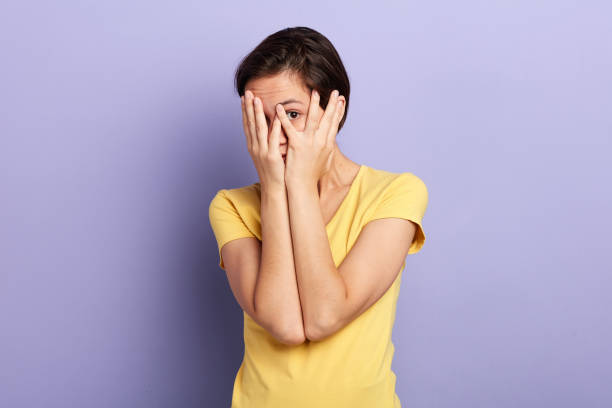 istock scared woman closing her face with palm 1227516221