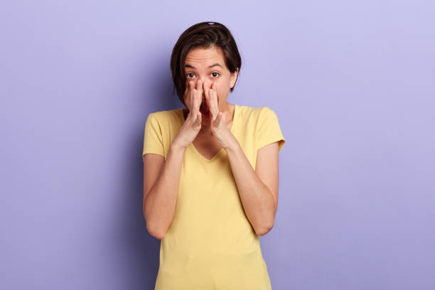 istock beaitiful girl with short blak hair calling someone. 1227516888
