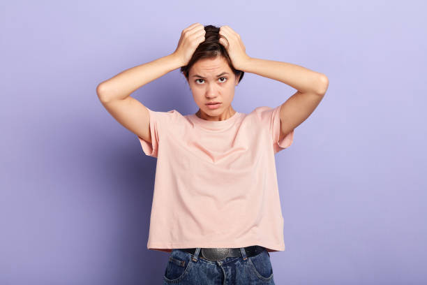 istock Young beautiful woman massaging her head. 1227516940