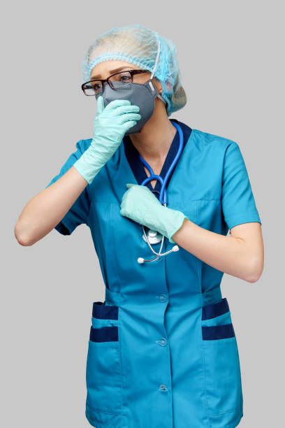 medical doctor nurse woman wearing protective mask and rubber or latex gloves - cough - cought imagens e fotografias de stock