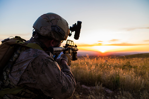 Army Soldier shooting at target at sunset