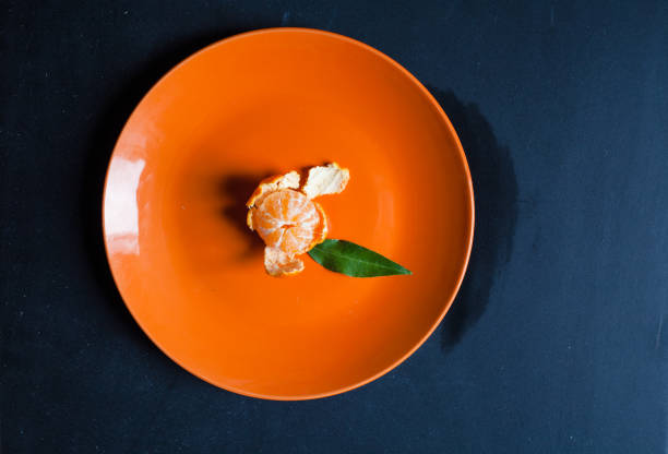 istock Orange Tangerine on Orange Dish 1227518924